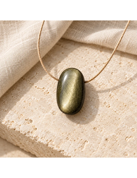 Pendentif ovale en obsidienne dorée AA sur pierre claire et lin – ambiance illustrative